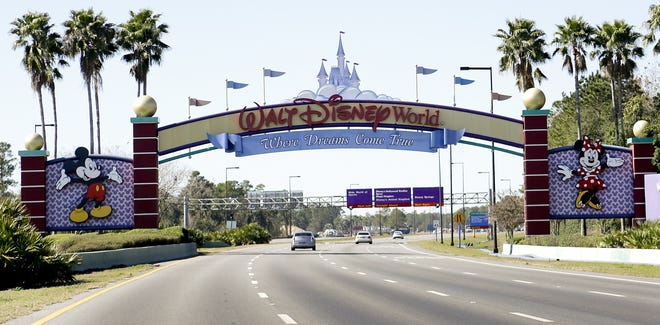 In this Tuesday, Jan. 31, 2017 photo, cars travel one of the roads leading to Walt Disney World in Lake Buena Vista, Fla. Orlando's top tourist destinations, Walt Disney World, Universal Orlando, SeaWorld and several resorts are in legal battles about how much they're worth with the local property appraiser and tax collector. (AP Photo/John Raoux)