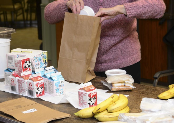 Volunteer Marian Gib of Ellwood City packs up a bag lunch for Meals on Wheels clients in the cafeteria in Ellwood City Hospital in November 2016. Anne Crowe, program coordinator for New Castle Meals on Wheels, said that the program will likely be unaffected by spending cuts to programs that fund Meals on Wheels nationwide in President Donald Trump's proposed federal budget.