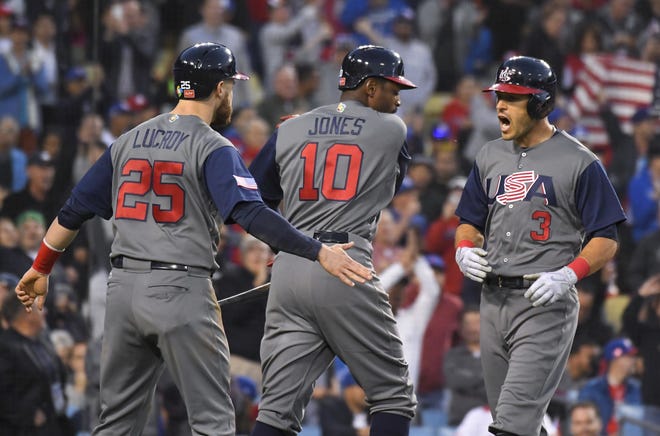 Team USA's Ian Kinsler, right, celebrates his two-run home run with Jonathan Lucroy, left, and Adam Jones during the championship game of the World Baseball Classic in Los Angeles on Wednesday. The United States beat Puerto Rico, 8-0, for its first WBC title. [The Associated Press]