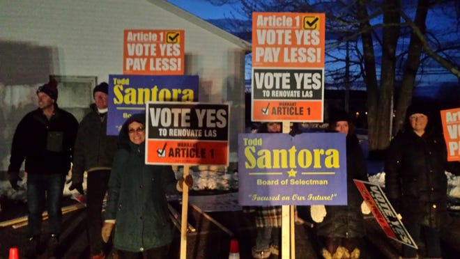 Hampton Falls residents held signs outside of Town Hall late in the day Thursday. Photo by Nancy Rineman