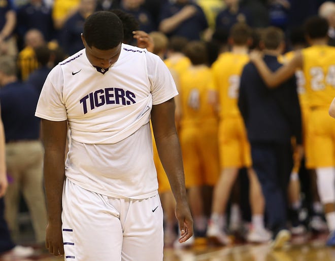 A dejected Juan Elmore of Pickerington Central walks off the court after the Tigers' loss to Cincinnati Moeller in a Division I state semifinal. [Lorrie Cecil/ThisWeek Newspapers]