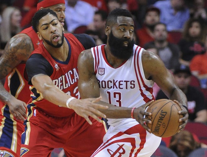 New Orleans Pelicans forward Anthony Davis (23) Anthony Davis (23) guards Houston Rockets guard James Harden (13) in the first half of Friday's game in Houston. [GEORGE BRIDGES/THE ASSOCIATED PRESS]