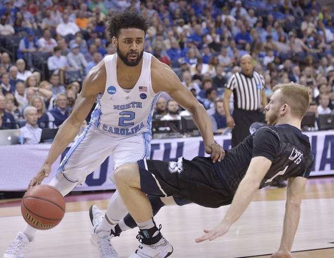 North Carolina guard Joel Berry II (2) moves past Butler guard Tyler Lewis in the first half of Friday's South Regional semifinal game in Memphis, Tenn. [Brandon Dill/The Associated Press]