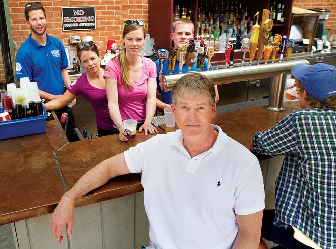 Paul Sorli, one of the owners of the Portsmouth Gas Light Co. restaurant, front, with some of his staff from left, Shane Buzzell, Rebecca Waitt, Jennifer Hanley and Mike Sorli. [Ioanna Raptis/Seacoastonline, file]
