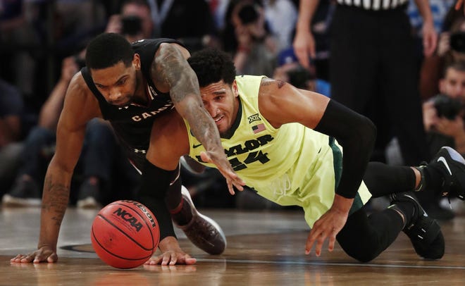 South Carolina guard Sindarius Thornwell, left, and Baylor guard Ishmail Wainright scramble for a loose ball in the second half of Friday night's game. [AP Photo/Julio Cortez]