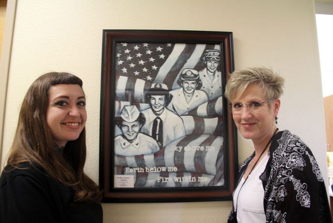 Artist Mimi Bailey, left, and Yreka VA Clinic administrative officer Debbie Kegg, stand next to Bailey's painting depicting women veterans, which was recently donated to the clinic.