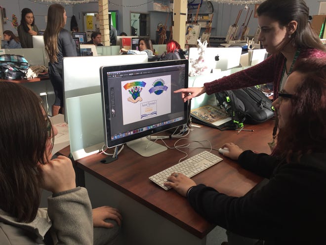 Greater New Bedford Regional Vocational Technical High School visual design students Julia Coucci, Mackenzie Piche’ and Sara Sequeira developing design concepts for a new sign at the Saint Teresa of Calcutta Children’s Playground. [Contributed Photo]