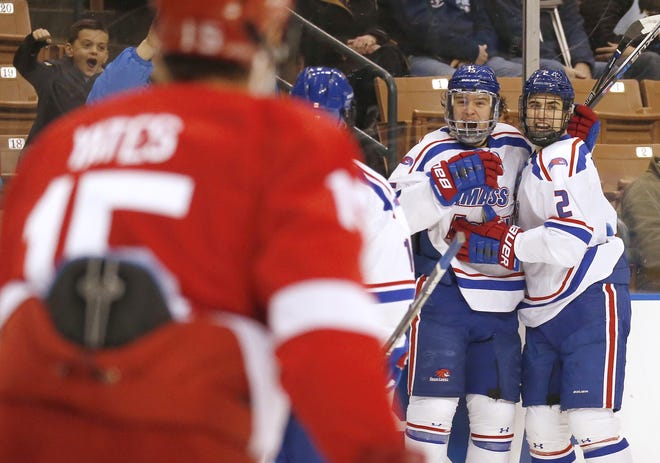 UMass Lowell's Ryan Dmowski, center, is congratulated by teammates, including Tommy Panico (2), after scoring a goal against Cornell during the first period of Saturday's NCAA regional semifinal game at SNHU Arena in Manchester.