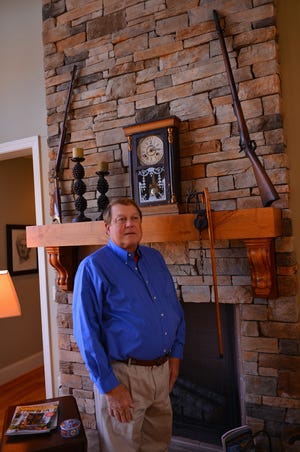 One of John Munn’s most cherished posses­sions resides on the wooden mantle of the floor-to-ceiling stacked-stone fireplace: one of the guns belonged to his grandfather, and the bent-wood cane and clock belonged to his great grandfather.