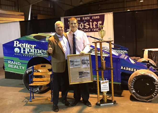 Better Homes and Gardens Rand Realty celebrated its championship wins for its #4RJ race car at a banquet held by the Orange County Fair Speedway in Middletown on March 4. The Rand-sponsored, dirt-modified car finished the season with its third win of 2016 at the Speedway track championship. The car is owned by Richard J. Smith, left, a hybrid agent for Better Homes and Gardens Rand Realty's Pine Bush office and Rand Commercial. Smith shared the driver's seat with his nephew, Tyler Boniface, right, who directed the car to its wins and the championship. [PHOTO PROVIDED]