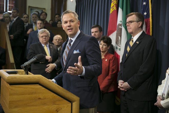 In this March 6, 2017 file photo, North Carolina Lt. Gov. Dan Forest, left, center, talks about his state's "bathroom bill," at the Capitol in Austin, Texas. Texas Lt. Gov. Dan Patrick. right, looks on. Forest is a strong supporter of the bill. He has accused news organizations of creating a false picture of economic upheaval. The Associated Press has determined that North Carolina's law limiting LGBT protections will cost the state more than $3 billion in lost business over a dozen years. THE ASSOCIATED PRESS