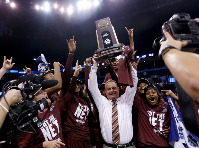 Mississippi State coach Vic Schaefer holds up the Oklahoma City Regional championship trophy after the Bulldogs beat top-seeded Baylor 94-85 in overtime Sunday at Chesapeake Energy Arena. [PHOTO BY SARAH PHIPPS, THE OKLAHOMAN]