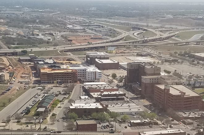 The east end of Bricktown is changing rapidly with construction of housing, shops, restaurants and hotels along with the opening last year of The Criterion music hall. But one gap remains between the Hilton Garden Inn and the music hall — a parking lot and empty parcel — that is now up for sale. [Photo by Steve Lackmeyer, The Oklahoman]