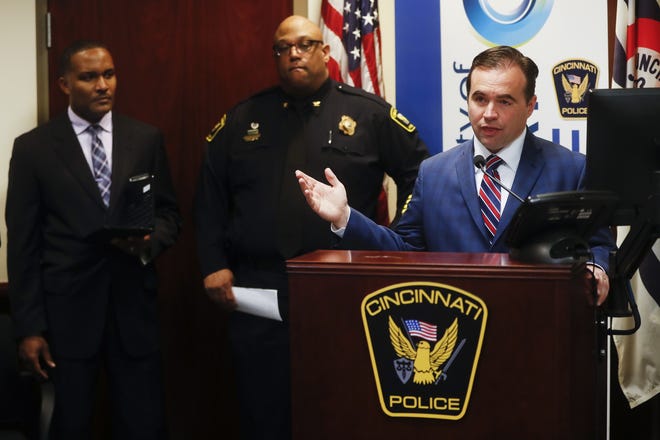 Cincinnati Mayor John Cranley speaks alongside police chief Eliot Isaac, center, and assistant fire chief Roy Winston, left, during a news conference at police headquarters regarding a fatal shooting at the Cameo club, Sunday, March 26, 2017, in Cincinnati. (AP Photo/John Minchillo)