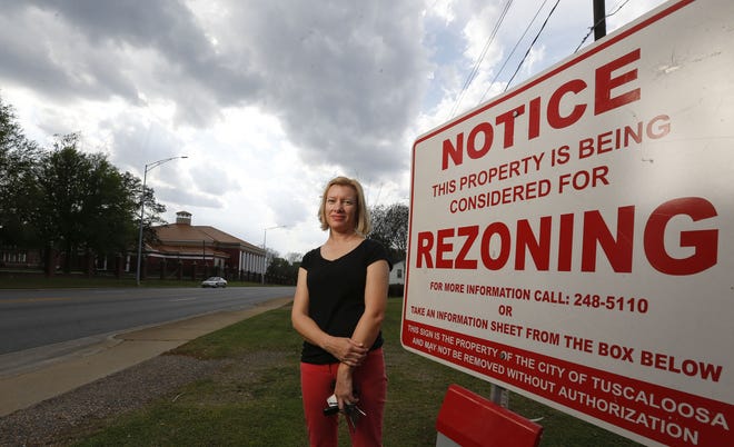 Serena Fortenberry, an opponent of the rezoning proposal on Stillman Boulevard., stands on the property on Monday. Some residents say bringing a fast-food restaurant to the area will increase traffic, noise and light pollution.

[Photo/Sam MacDonald]