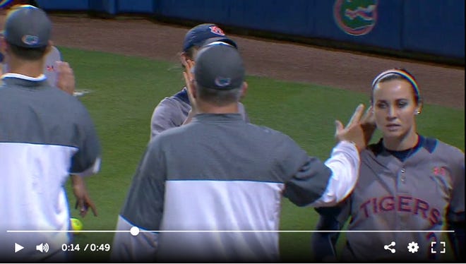 This image from an ESPN video shows Florida softball coach Tim Walton contacting Auburn player Haley Fagan's shoulder following a game Monday.