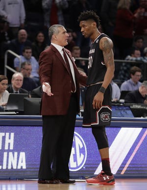 South Carolina head coach Frank Martin talks with forward Chris Silva during the second half of the East Regional championship against Florida on Sunday in New York. [Julio Cortez/The Associated Press]