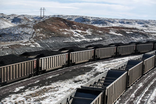 In this Jan. 9, 2014, file photo, rail cars are filled with coal and sprayed with a topper agent to suppress dust at Cloud Peak Energy's Antelope Mine north of Douglas, Wyo. President Trump's latest move to support coal mining is unlikely to turn around the industry's prospects immediately. Experts say the biggest problem faced by the mining industry today is an abundance of cheap natural gas. THE ASSOCIATED PRESS