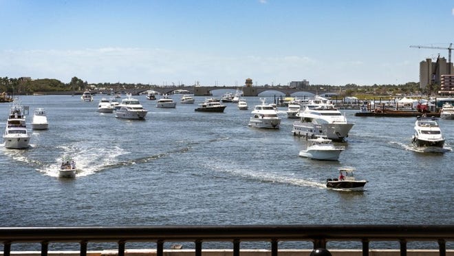 Boats jockey for an opportunity to get past the Flagler Memorial Bridge as it opens Monday morning. (Melanie Bell / Daily News)