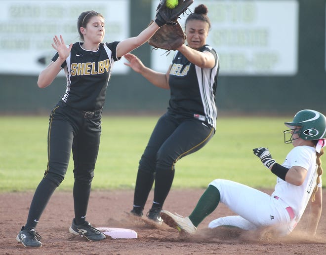 Shelby's Taylor Canipe. left, forces Charger runner Jenna Wacaster Tuesday afternoon on a close play at second base at Crest. [Hannah Dunaway/ The Star]