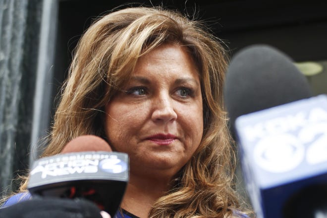 FILE- In this June 27, 2016, file photo, "Dance Moms" star Abby Lee Miller leaves federal court after pleading guilty in Pittsburgh to bankruptcy fraud and failing to report thousands of dollars in Australian currency she brought into the country. Miller posted on Instagram March 26, 2017, that she quit the Lifetime series. (AP Photo/Keith Srakocic, File)