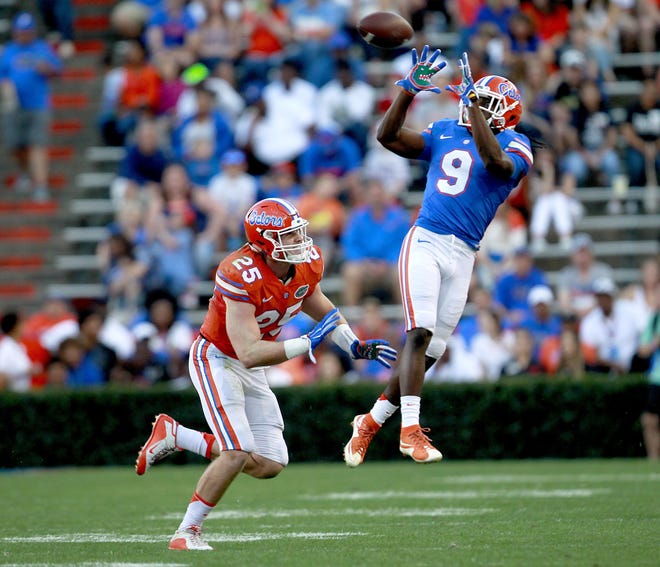 Florida receiver Dre Massey jumps to make a catch in front of Florida linebacker Matt Rolin during a spring football game on April 8, 2016, in Gainesville. Massey is coming off a knee injury that cost him just about all of the 2016 season. [Matt Stamey / Gatehouse Media]