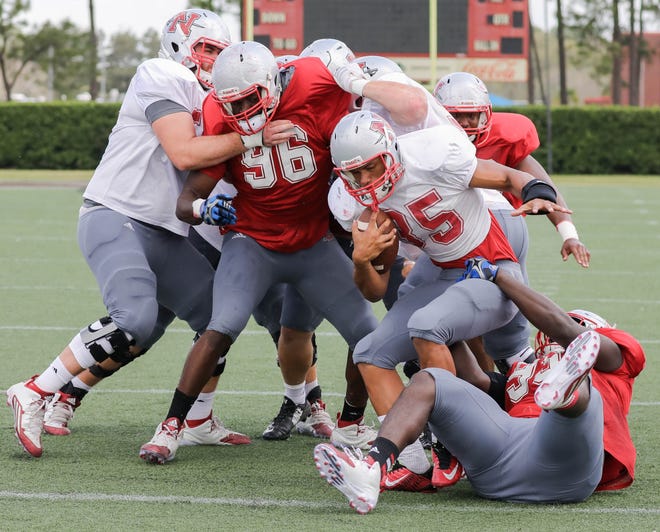 Nicholls defensive lineman Tevin Lawson (96) breaks through the line of scrimmage in pursuit of running back Donnell Adair (35) during Saturday's scrimmage at John L. Guidry Stadium in Thibodaux. [BERT MILLER/CORRESPONDENT – HOUMATODAY/DAILYCOMET]
