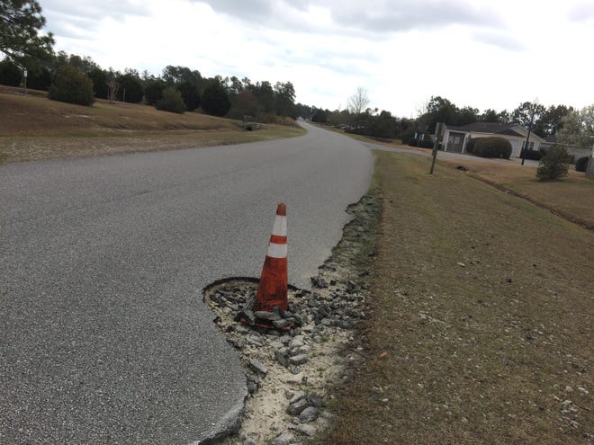 A traffic cone warns motorists of a pothole on Lendire Road in Ogden. The N.C. Department of Transportation will close a portion of Lendire Road for six months to construct a new connecting intersection with Middle Sound Loop Road. [STARNEWS FILE PHOTO]