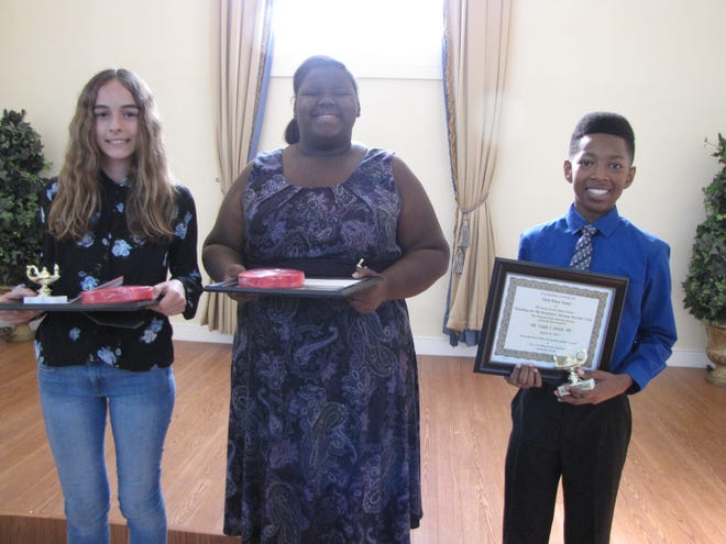The winners of the essay contest were, from left, Phoebe Hailey, who won third place and wrote about Marihelen Wheeler, a retired educator who ran an unsuccessful campaign last fall for Florida House District 21; Jonia Stover, who won second place and wrote about poet, author and social activist Langston Hughes, and Caleb J. Smith, who won first place and wrote about his grandmother, Mary Elizabeth Winston Mason. [Photos by Aida Mallard/Special to the Guardian]