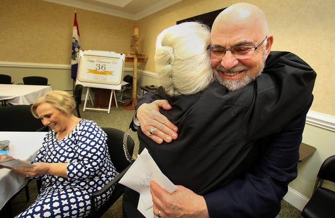 Gastonia City Manager Ed Munn gets a hug from Lucy Penegar during his farewell reception in the upstairs conference room at City Hall on South Street on Thursday afternoon, March 30, 2017. Munn is retiring after a 36-year career in Gastonia , which included nine years as city manager. [MIKE HENSDILL/THE GAZETTE]