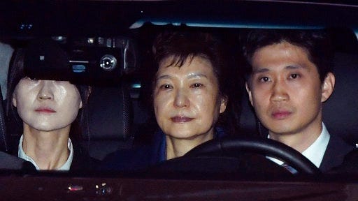 Former South Korean President Park Geun-hye, center, arrives at a detention center in Uiwang, South Korea, Friday, March 31, 2017. Park was arrested and jailed Friday over high-profile corruption allegations that already ended her tumultuous four-year rule and prompted an election to find her successor. (Cho Sung-bong/Newis via AP)