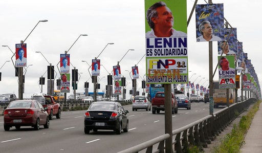 Cars cross a bridge flanked by campaign posters promoting presidential candidate Guillermo Lasso of the CREO party, left, and opponent Lenin Moreno, the presidential candidate representing the ruling party Alliance PAIS, in Guayaquil, Ecuador, Wednesday, March 29, 2017. Until recently, Ecuador looked like the next domino to fall in a right-wing resurgence taking place across Latin America. Voters looked poised to kick out the leftists who have ruled for a decade and hand power to conservative banker Lasso. But the race now appears to be extremely tight thanks to a late surge by Moreno, President Rafael Correa’s hand-picked successor. (AP Photo/Fernando Vergara)