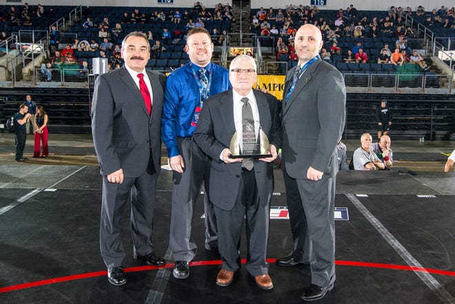 Henry Marsh, third from left, stands with, from left, National Collegiate Wrestling Association executive director Jim Giunta, NCWA board member Bryan Knipper and NCWA executive board member Kevin Andres at the NCWA Championships Hall of Fame induction ceremony earlier this month at the Allen Event Center in Allen, Texas. [Courtesy photo]