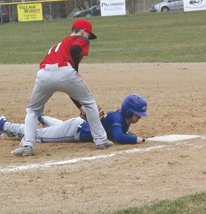 Centreville’s Chad Spence dives back to first during action Wednesday in Colon.