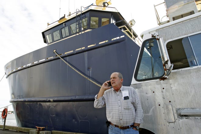 Fishing mogul Carlos Rafael is pictured in 2014 on Homer's Wharf in New Bedford, in front of his herring boat, F/V Voyager. John Sladewski / Standard-Times file photo/SCMG