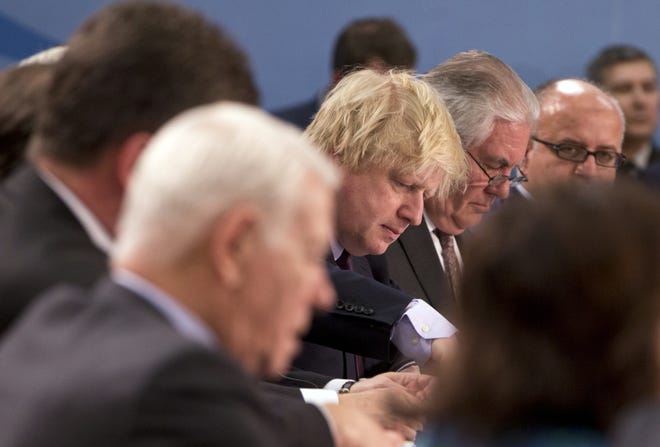 British Foreign Secretary Boris Johnson, center left, and U.S. Secretary of State Rex Tillerson, center right, look down at their papers during a meeting of the NATO-Ukraine Commission at NATO headquarters in Brussels on Friday, March 31, 2017. U.S. Secretary of State Rex Tillerson meets with his NATO counterparts in Brussels for the first time looking to persuade reluctant allies to increase defense spending and do more to combat terrorism. THE ASSOCIATED PRESS