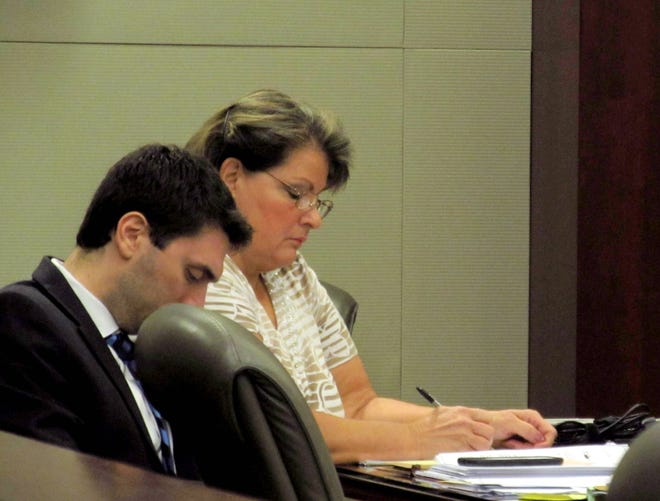 Ex-Flagler elections chief Kimberle Weeks, right, sits next to one of her attorneys as she takes notes during a hearing in February to suppress evidence recovered from her offices in October 2014. A judge on Friday dismissed four more of the charges against Weeks, but denied a defense motion to suppress evidence in the case. [News-Journal file/Matt Bruce]