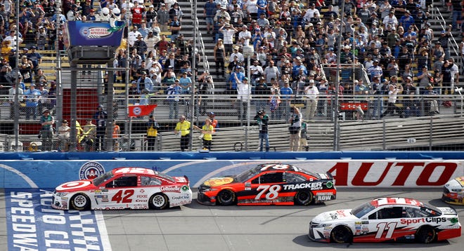 Kyle Larson (42) leads in front of Martin Truex Jr. (78) and Denny Hamlin (11) in final laps of the NASCAR Cup Series auto race at Auto Club Speedway in Fontana, Calif., Sunday, March 26, 2017. Larson won the race. (AP Photo/Alex Gallardo)