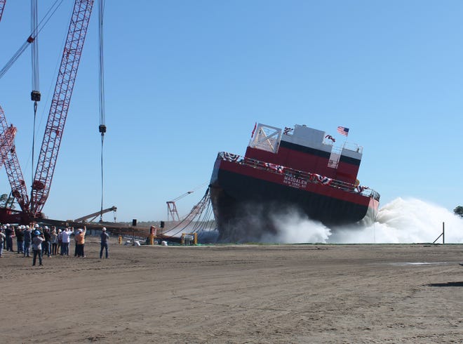 The M/V Magdalen, a 356-foot-dredger, splashes into the water Friday at Eastern Shipbuilding's Allanton Shipyard. [CAREY BRAUER/THE NEWS HERALD]