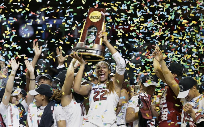 South Carolina forward A'ja Wilson (22) holds the trophy as she and her teammates celebrate a win over Mississippi State in the final of NCAA women's Final Four college basketball tournament, Sunday, April 2, 2017, in Dallas. South Carolina won 67-55. (AP Photo/Tony Gutierrez)