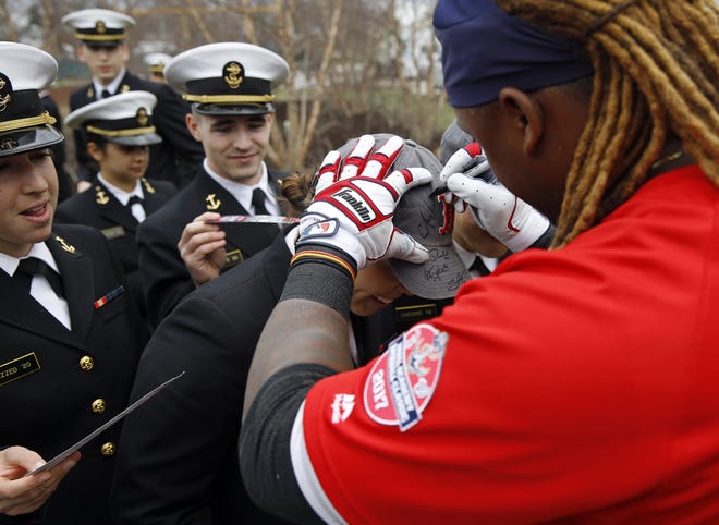 Boston Red Sox first baseman Hanley Ramirez autographs a Midshipman's cap before an exhibition baseball game against the Washington Nationals at the U.S. Naval Academy in Annapolis, Md., on Saturday. [Photo by AP]