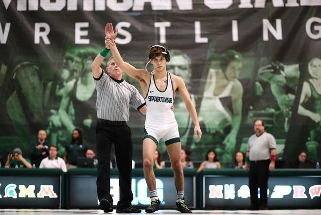 Michigan State wrestler Mitch Rogaliner is declared the winner in his match in the Spartans' 24-15 dual meet loss to Michigan on Feb. 5. Rogaliner is leaving a year of eligibility on the table in order to prepare for medical school. The Bedford graduate plans to focus on pediatrics. (Photo courtesy of REY DEL RIO)