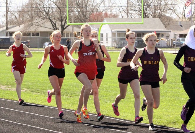 Pekin's Paige Arseneau, center, competes in the 1600 at the Lady Dragon Relays. She finished fourth in 5:36.