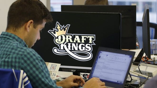 In this Sept. 9, 2015, file photo, Bear Duker, a marketing manager for strategic partnerships at DraftKings, works at his computer at the company headquarters in Boston.AP Photo/Stephan Savoia