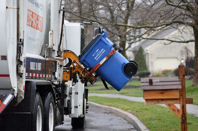 A McCullough Rubbish Removal truck picks up trash on Friday, March 31, 2017. Each township must require residents to have trash and recycling services so the town can receive a performance grant from the state Department of Environmental Protection.