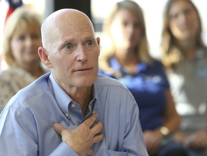 Florida Gov. Rick Scott speaks during a roundtable discussion about the local economic impact of VISIT FLORIDA and Enterprise Florida in Panama City Beach, Fla., Tuesday, Feb. 14, 2017. (Andrew Wardlow/News Herald via AP)