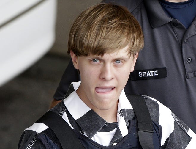 In this June 18, 2015, file photo, Charleston, S.C., shooting suspect Dylann Storm Roof is escorted from the Cleveland County Courthouse in Shelby, N.C.  Solicitor Scarlett Wilson told The Associated Press on Friday, March 31, 2017, that Roof is scheduled to enter a guilty plea during a hearing on April 10 in Charleston. The plea on all of his state charges, including nine counts of murder, comes in exchange for a sentence of life in prison, the prosecutor said. Roof has been awaiting trial on state murder charges for the deaths of nine black parishioners at Charleston's Emanuel AME Church in June 2015. THE ASSOCIATED PRESS