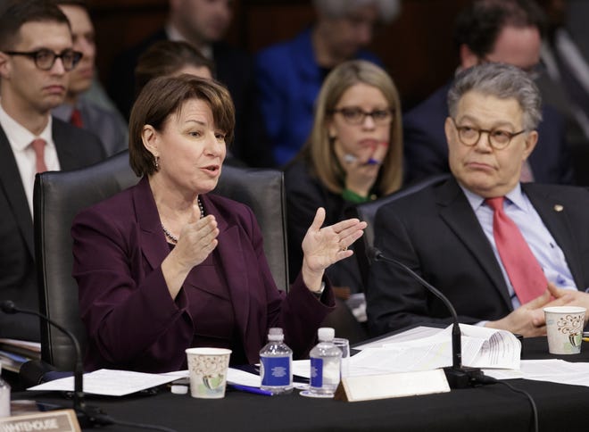 Democratic members of the Senate Judiciary Committee, Sen. Amy Klobuchar, D-Minn., left, and Sen. Al Franken, D-Minn., question the Republican side as the panel meets to advance the nomination of President Donald Trump's Supreme Court nominee Neil Gorsuch, Monday, April 3, 2017, on Capitol Hill in Washington. THE ASSOCIATED PRESS