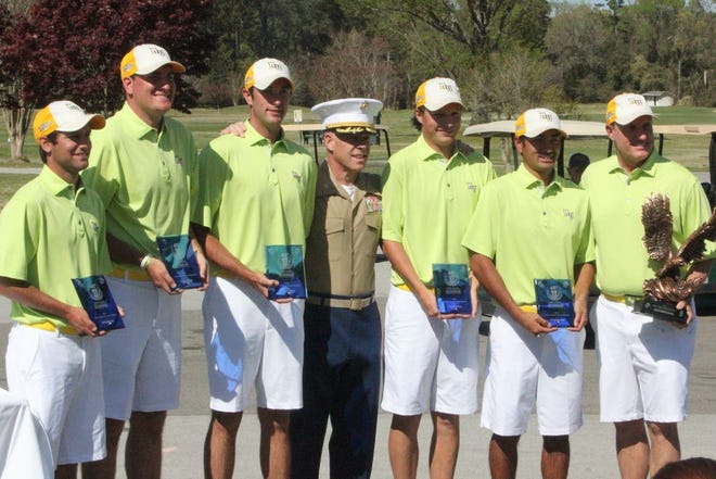 Methodist players pose with Col. Chandler Seagraves after accepting the first-place trophy from him for winning their 11th Intercollegiate Golf Championship on Sunday at Paradise Point Golf Course aboard Camp Lejeune.