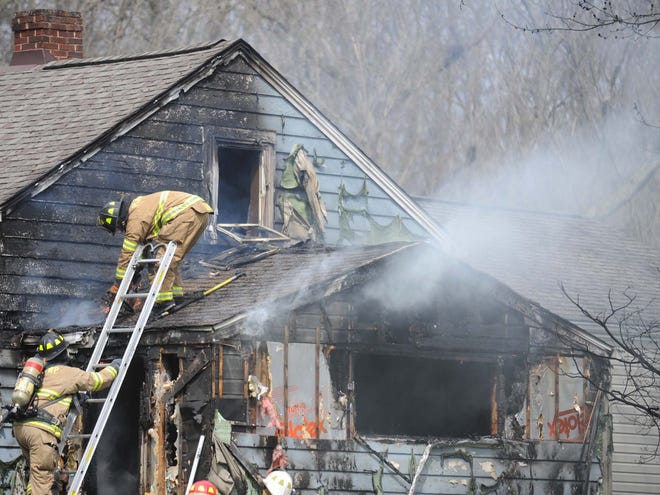 Firefighters with Plain and Jackson Townships work to extingish as house fire at 4033 Hiram Road NW in Plain Township Monday, Apr. 03, 2017. (CantonRep.com / Julie Vennitti)